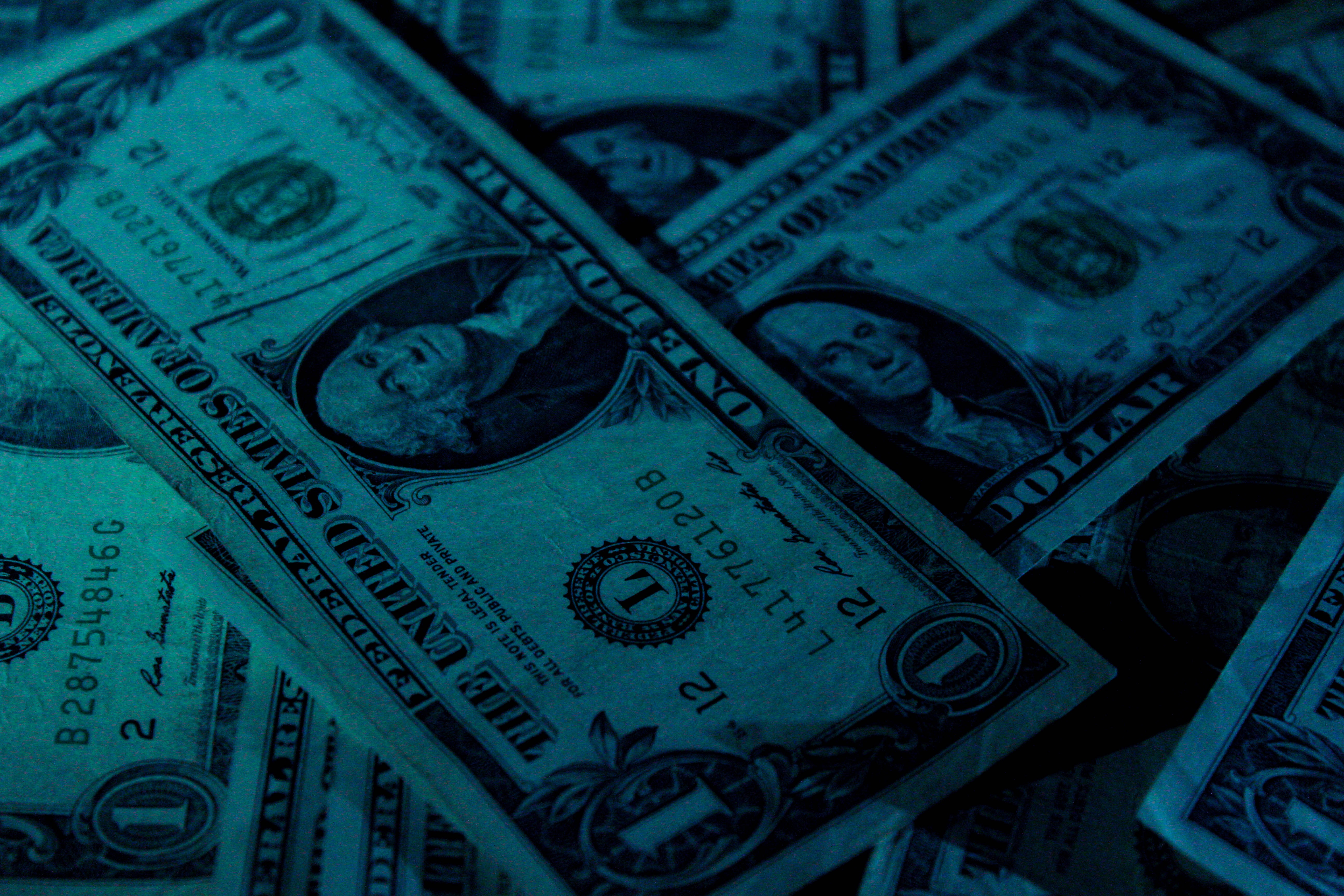 pile of one dollar bills