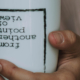 Hand holding a cup with upside down text reading "from another point of view"