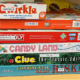 Stack of games such as Candy Land, Clue, and Risk
