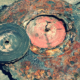 Melted vinyl record resting on fire-damaged turn table