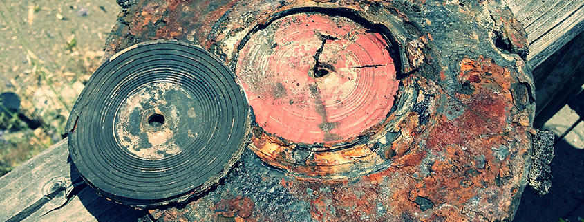 Melted vinyl record resting on fire-damaged turn table